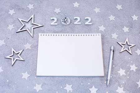 White sheet of notebook with pen on festive gray background.の写真素材