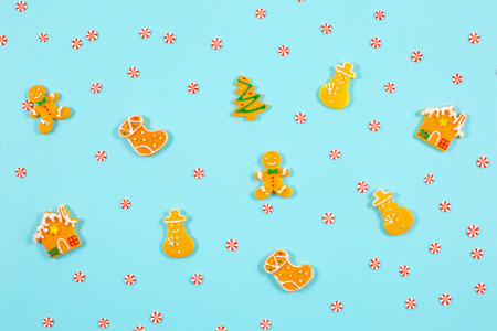 Decorative winter pattern from various gingerbread cookies on blue background.