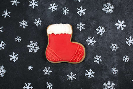 Tasty gingerbread cookie in shape of Boot and snowflakes on dark background.の写真素材