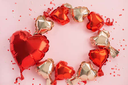 One big red and many small Air Balloons of heart shaped foilの写真素材