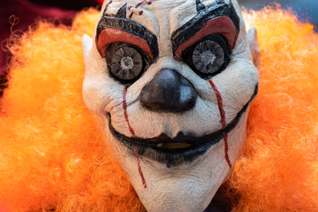 Portrait of bad bloody clown with orange hair. Horror Clown. Blood freak.