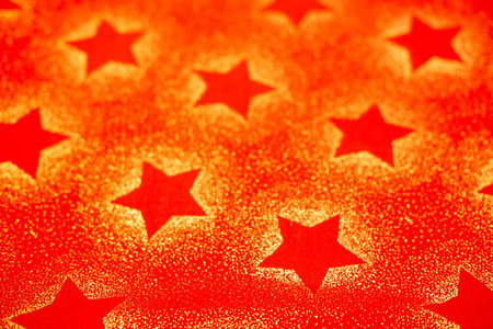 Red background with stars with sequins. christmas background fabric