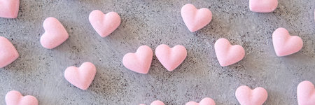 Valentines Day background. Banner. sugar sweet pink confetti on concrete background.