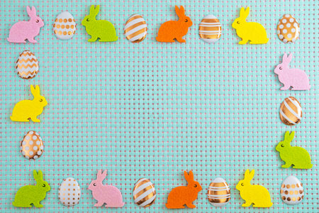 Colorfull eggs andl rabbits on blue background