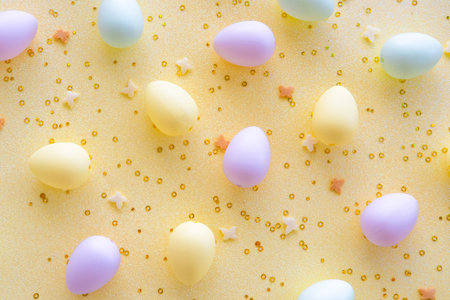 Colorful Easter eggs and confetti on YELLOW background. Egg hunting.の写真素材