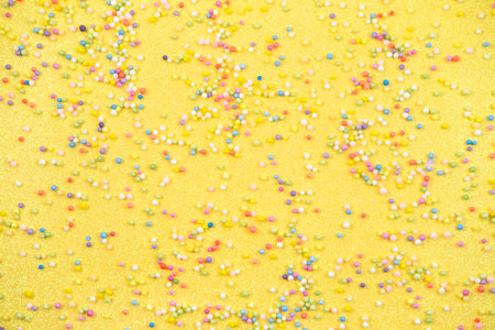Colorful Confetti scattered on yellow background. Festive confetti.の写真素材