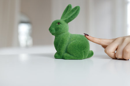 Easter Bunny Rabbit Statue. The girl touches the Easter bunny. Close up, copy space.の写真素材