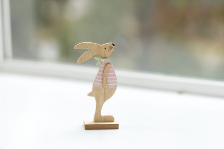 Handmade Easter Bunny. Blurred background. Easter toys. Wooden Easter eggs on white background, copy...