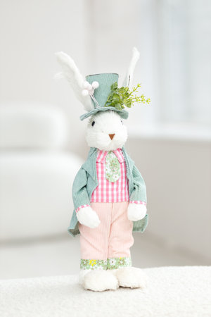 Handmade Easter Bunny. Blurred background. Easter toys. Wooden Easter eggs on white background, copy space.の写真素材