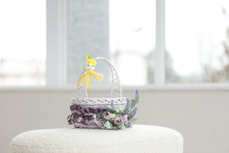 Easter toys. Easter basket with a decorative rabbit in the hands of a man. Blurred background, copy space.の写真素材