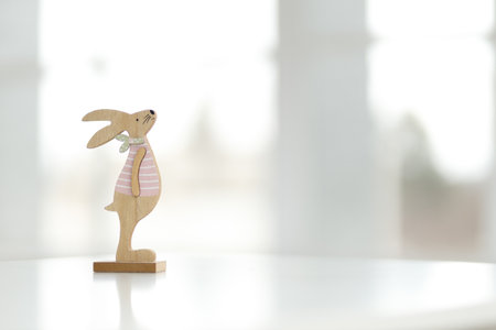 Wooden Easter bunny and decorative eggs. Blurred background, copy spaceの写真素材