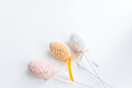 Easter toys. Wooden Easter eggs on white background, copy space.の写真素材