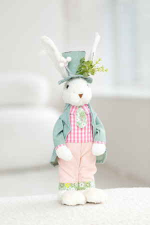 Handmade Easter Bunny. Blurred background. Easter toys. Wooden Easter eggs on white background, copy space.の写真素材