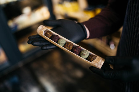energy balls. Healthy raw dessert (balls of bliss), vegetarian truffles, sugar-free candies made of dates, hazelnuts, cocoa powder. dark background.の写真素材