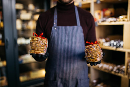 Round fluted baked Belgian waffles. The confectioner holds the waffles in his hand.
