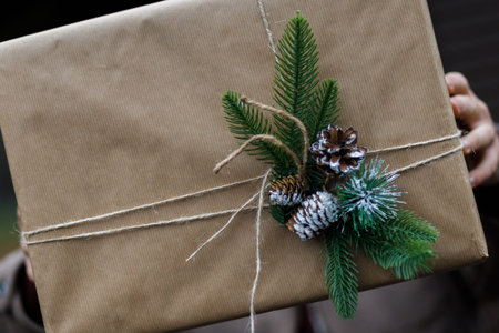 A couple exchange gifts. beautiful gift. New Year's decor. Preparation for the holiday. Gift on a...