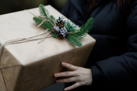 beautiful gift. New Year's decor. A girl holds a New Year's gift in his hands. Preparation for the holiday. close up. COPY SPACE.の写真素材