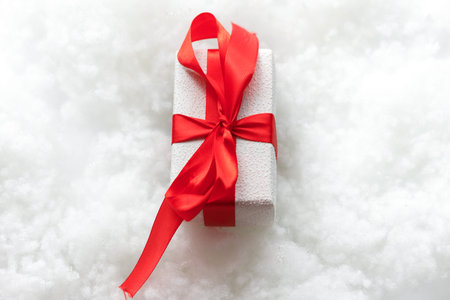 beautiful gift. New Year's decor. Preparation for the holiday. White snow background. close up. COPY...