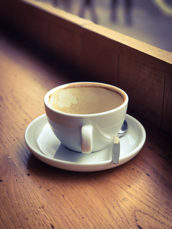 Empty coffee cup on the window side table.の写真素材