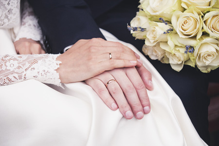newlyweds hands with wedding rings. Bride and groomの写真素材
