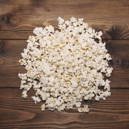 Circle of popcorn on brown wooden backgroundの写真素材