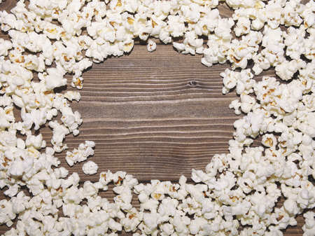 Round frame of popcorn on wooden backgroundの写真素材