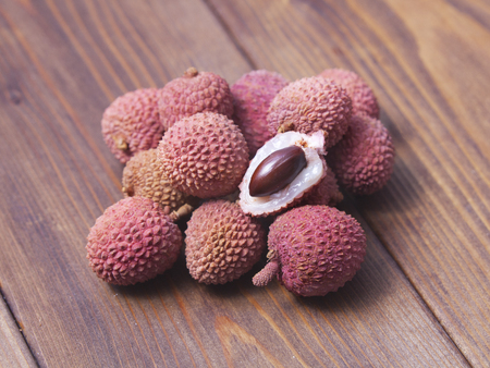 fresh pink lychee fruits on wooden backgroundの写真素材