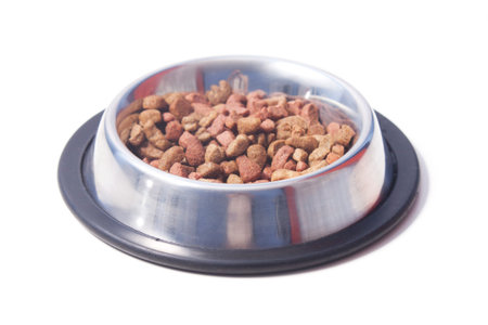 Balanced dry cat food in a bowl. Isolated on white background