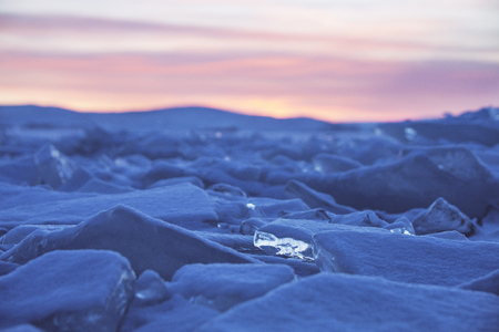 Ice on Lake Baikal, winter nature. Sunset landscape.の写真素材