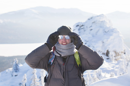 Man near rocks. Snow. Mountain range Zyuratkul, winter landscape.の写真素材