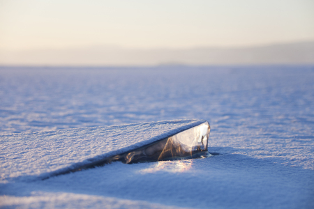 Ice on Lake Baikal, winter nature. Sunset landscape.の写真素材
