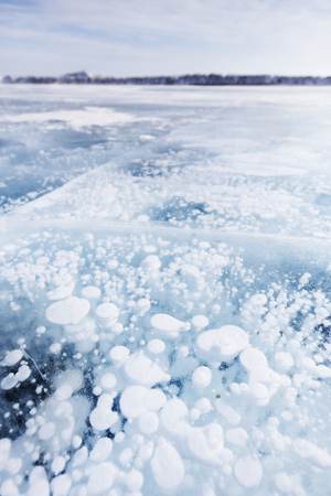 Gas bubbles in ice of Baikal lake. Winter landscapeの写真素材