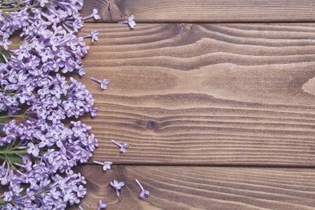 Brown wooden background with fresh lilac flowersの写真素材