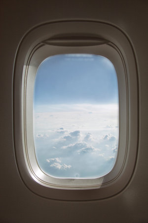 Blue sky with clouds. View from the plane windowの写真素材