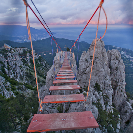 Suspension red bridge. Ai-Petri cliffs. Crimean mountains. Sunsetの写真素材