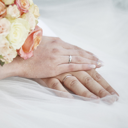 newlyweds hands with wedding rings.の写真素材
