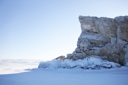 Rocky island in small sea of lake Baikal. Winter landscapeの写真素材