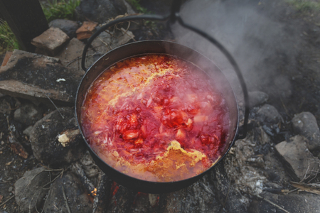 Borscht in pot on fire. Dinner in countryside の写真素材