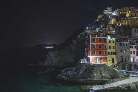 Riomaggiore city on the rocky seashore. Cinca Terre. Italy. Night viewの写真素材