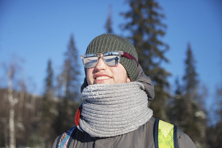 Portrait of a young man wrapped in a scarf. Cold winterの写真素材