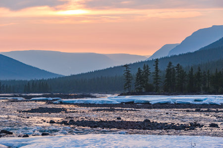 Snow and ice on the banks of the river Hoisey. Polar day on Putorana Plateau, Taimyr