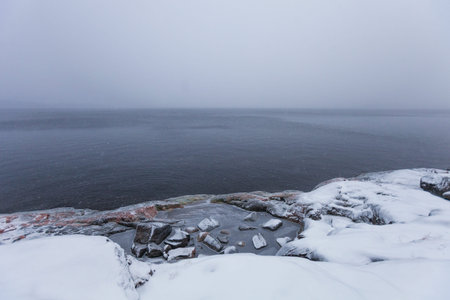 Blizzard on the rocky shore of Lake Ladoga. Leningrad region landscape, Russiaの写真素材