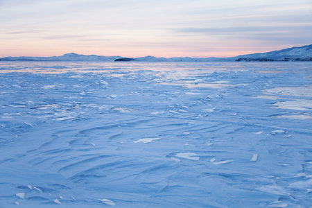Lake Baikal, winter. Cape Uyuga sunset landscape. Wavy snow