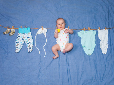 Fantasy. Baby is drying on a rope along with baby clothes