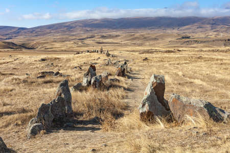 Standing stones in Zorats-Karer or Karahunj. Ancient megalithic complex, on a mountain plateau at an altitude of 1770 meters above sea level, Syunik region of Armenia. Historical and cultural reserveの写真素材