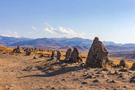 Standing stones in Zorats-Karer or Karahunj. Ancient megalithic complex, on a mountain plateau at an altitude of 1770 meters above sea level, Syunik region of Armenia. Historical and cultural reserveの写真素材