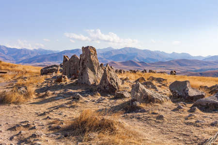 Standing stones in Zorats-Karer or Karahunj. Ancient megalithic complex, on a mountain plateau at an altitude of 1770 meters above sea level, Syunik region of Armenia. Historical and cultural reserveの写真素材