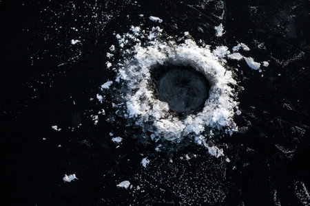 Frosty fishing hole on ice. Winter fishingの写真素材