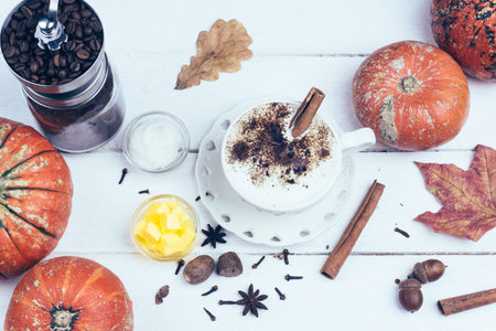 Bulletproof coffee. Ketogenic diet coffee with coconut oil and butter (ghee). Cup of bulletproof coffee and ingredients, paleo diet. On white wooden backgroundの写真素材