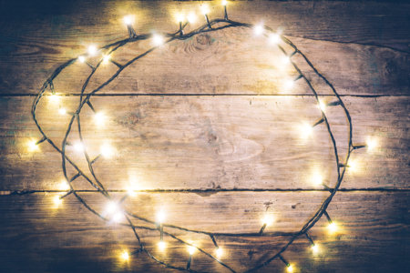 Christmas lights frame. Christmas wooden rustic background with (decorated) christmas lights. Copy...